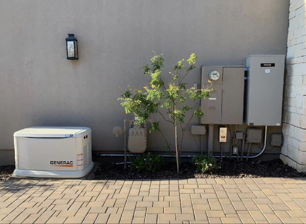 Residential service equipment — generator and electrical panel outside a Phoenix home